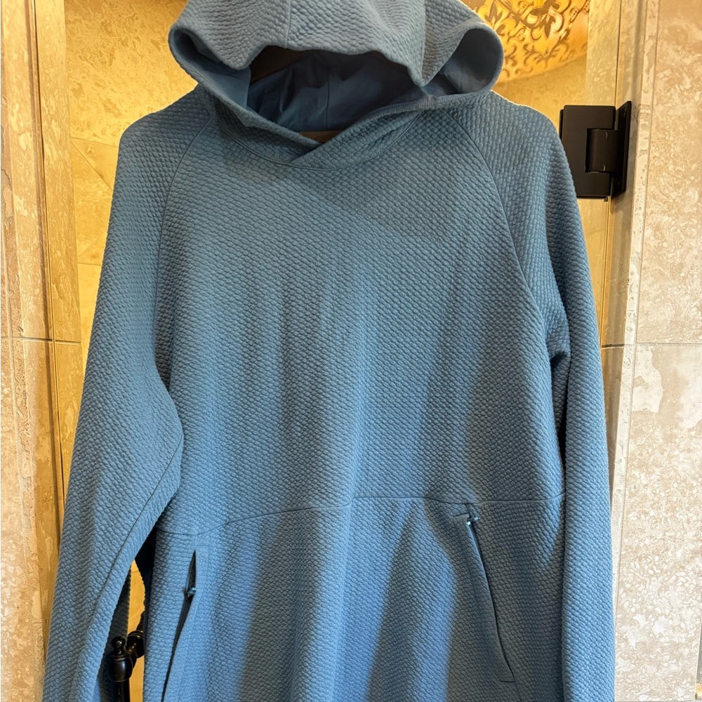 Men’s Lululemon Blue Textured Hoodie with zip pockets.